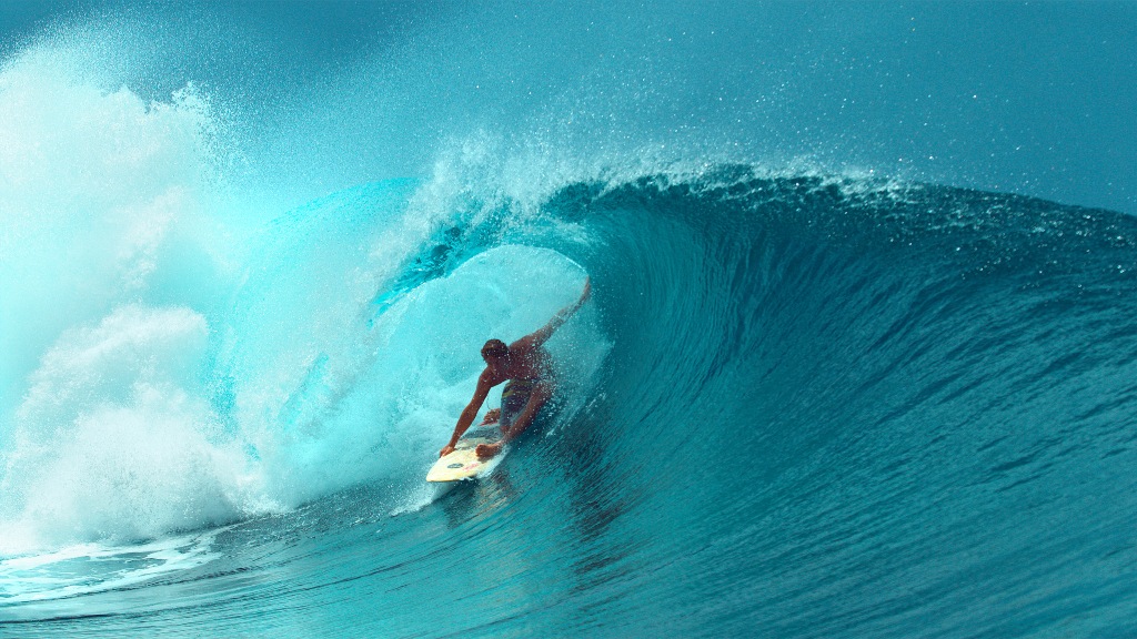 Surfer riding a big wave/ surf equipment