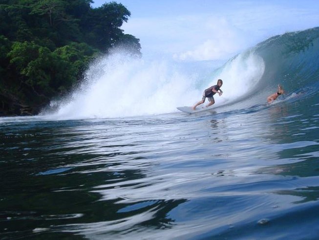 Surfer riding a barrel wave in tropical surf in Panama at Surfer Paradise Surf Camp