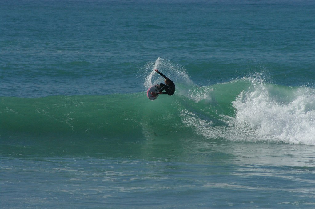 Surfer at La Source in Taghazout riding a wave